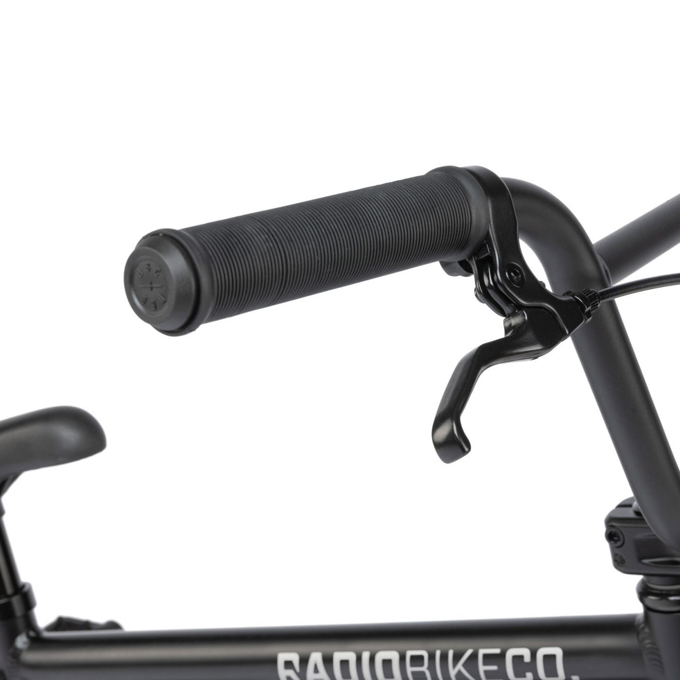 Close-up of a black bicycle handlebar with a textured rubber grip and brake lever on the Radio Dice 18 Inch Bike.