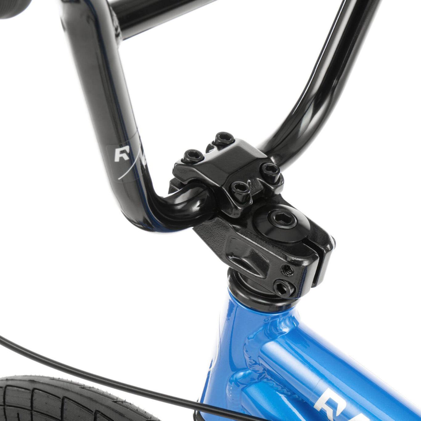 Close-up view of a Radio Dice 18 Inch Bike's black handlebar and stem, attached to a blue frame. The Salt Tracer Tyres and part of the logo are visible.