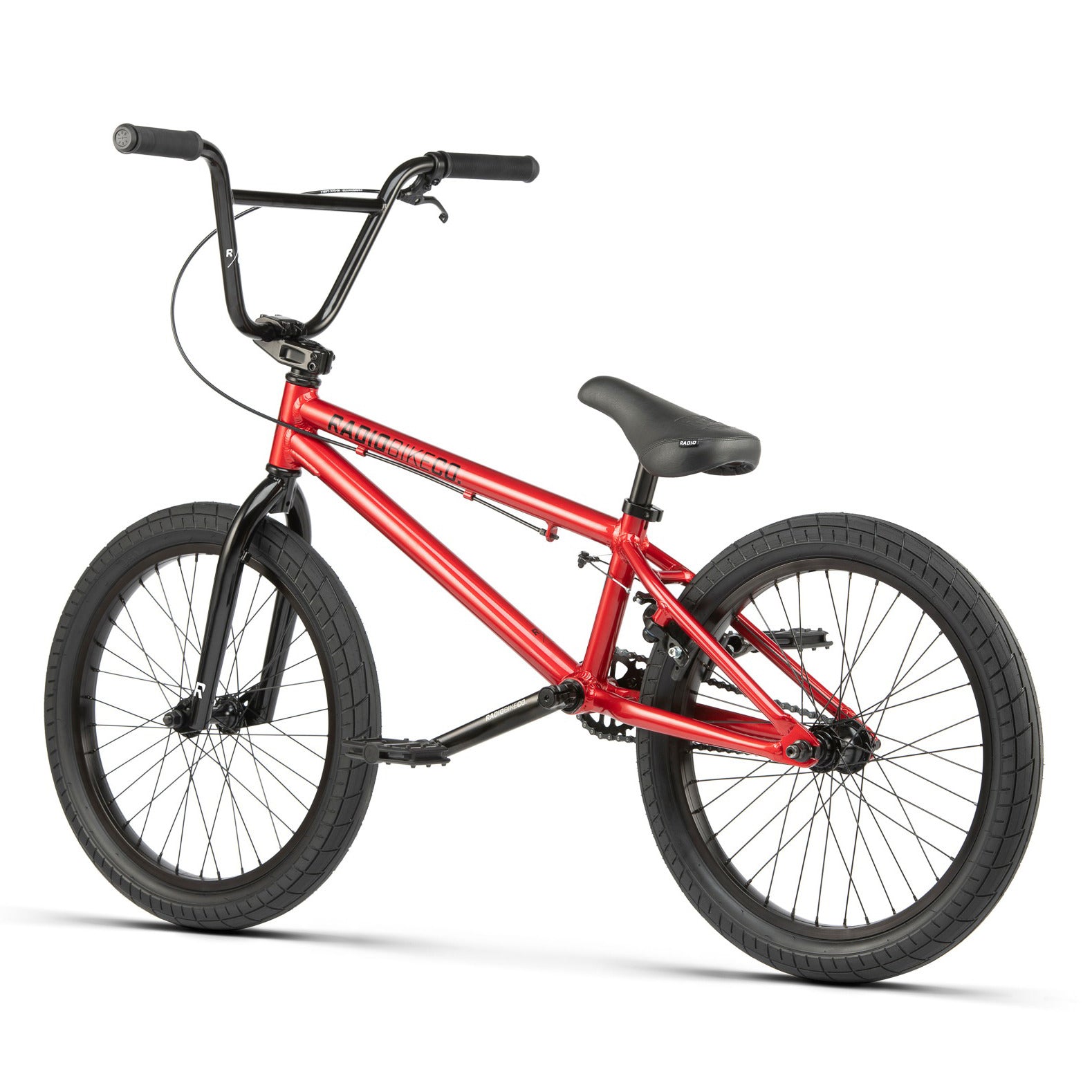 A red BMX bike with black handlebars, saddle, and Salt Tracer tires. The Radio Dice 20 Inch Bike features a compact 6061 Alloy frame and freestyle pegs on the rear wheel.
