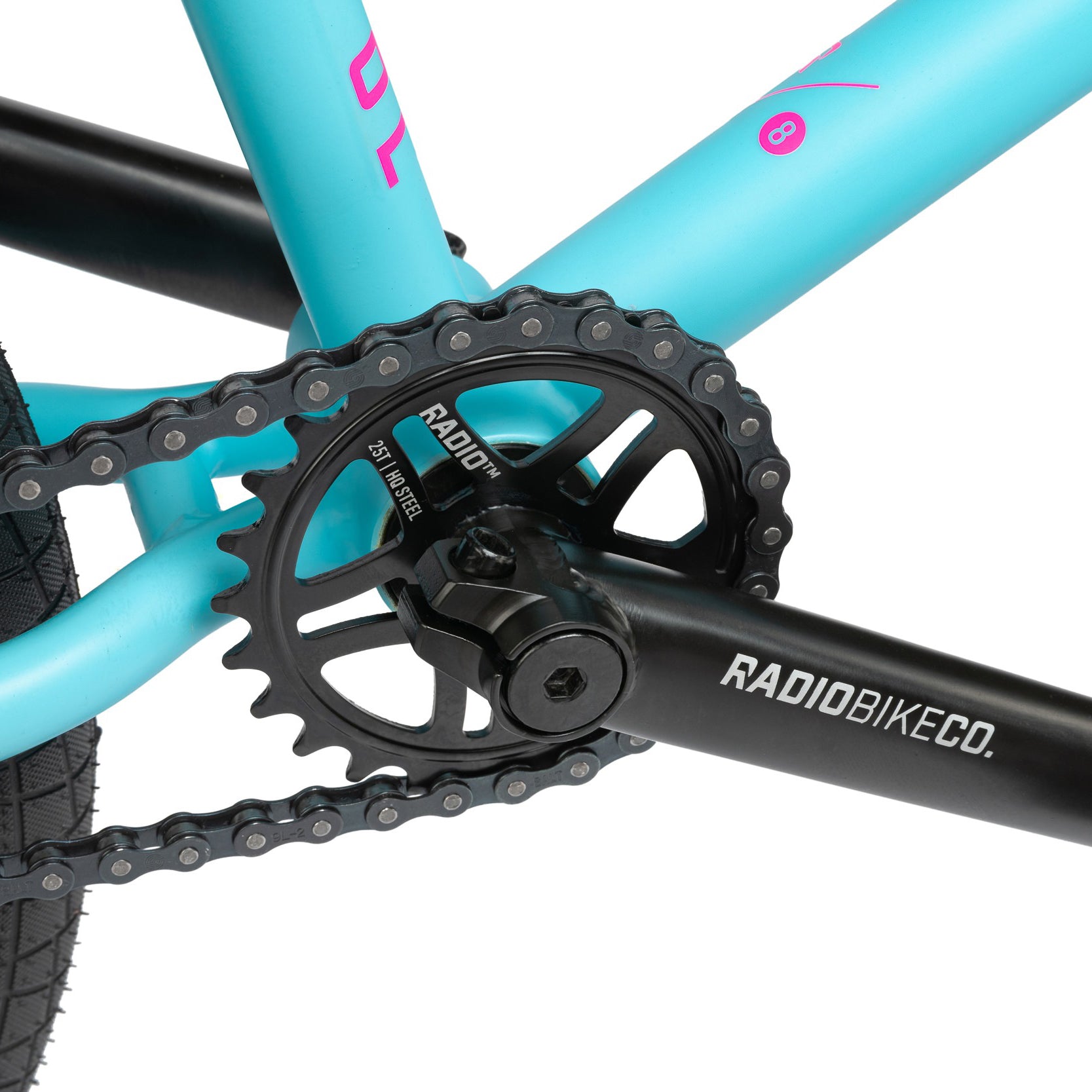 Close-up view of a Radio Bike Co. crankset featuring a black chainring and crank arm, seamlessly integrated into the teal frame of the Radio Evol 20 Inch Bike—an excellent choice for beginner riders due to its high-quality bike parts.