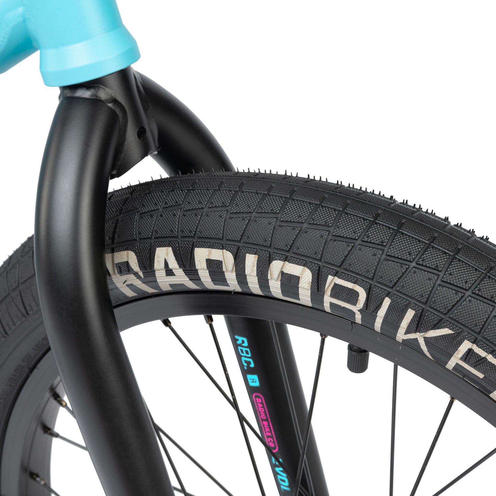 Close-up view of the front wheel of a Radio Evol 20 Inch Bike, featuring a black tire branded with "RADIORIKE" and a blue frame, highlighting the high-quality bike parts designed for beginner riders.