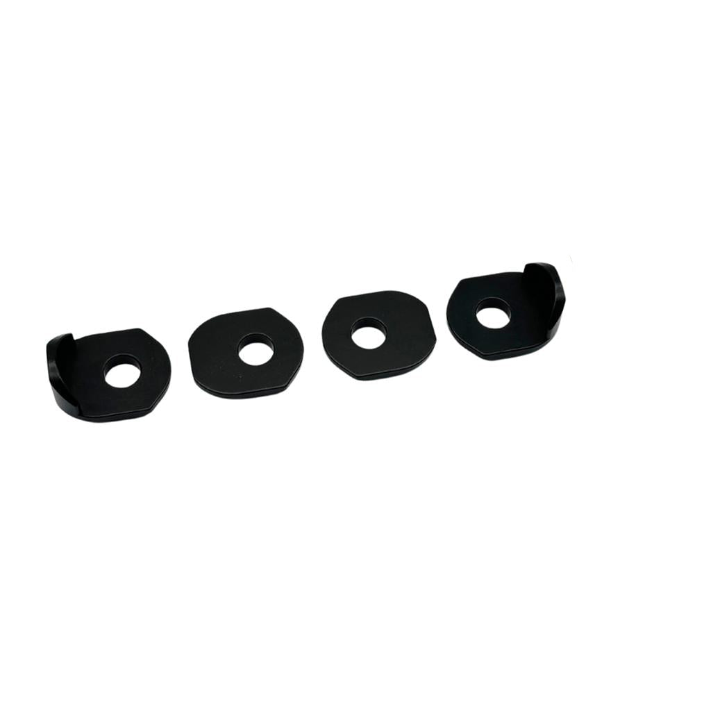 A Radio Raceline Helium Pro / Quartz Dropout Plate, featuring four black metal washers and two bolts with nuts, is arranged on a white backdrop evoking precision engineering.