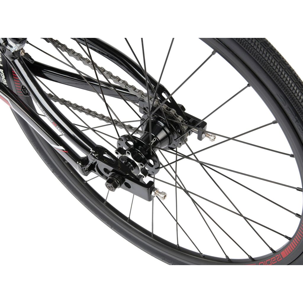 A close up of a Radio Xenon Mini Bike wheel with red spokes and a disc brake.