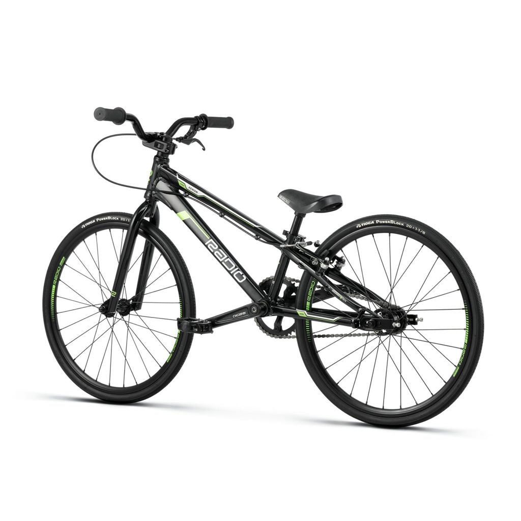 A black and green Radio Xenon Mini Bike with a lightweight frame, flat handlebars, and large Tioga Powerblocks tires designed for racing or freestyle riding.