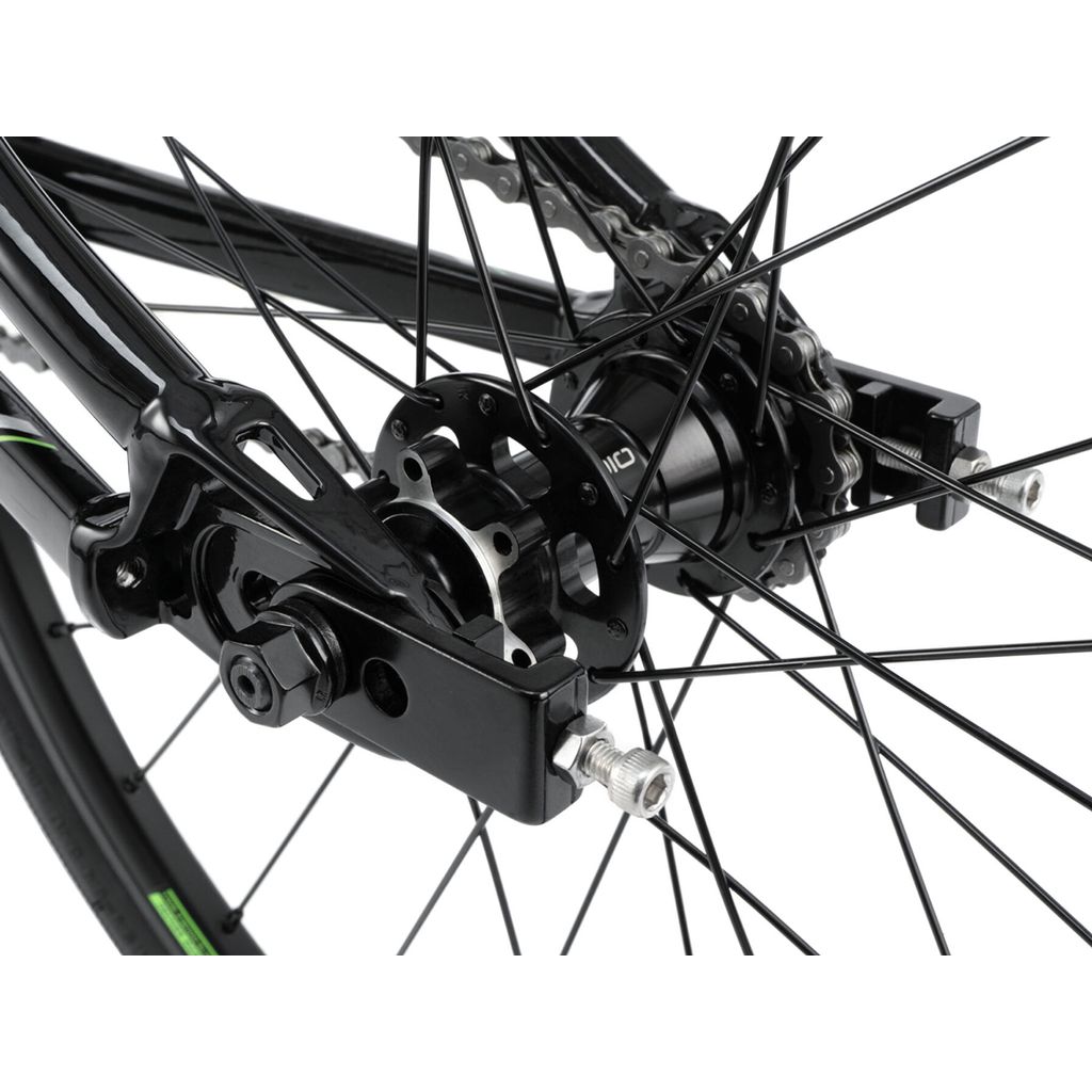 Close-up view of a Radio Xenon Mini Bike's rear wheel hub, showcasing the intricate spokes, chain, and part of the frame crafted from hydro-formed 6061-T6 alloy in a sleek black finish.