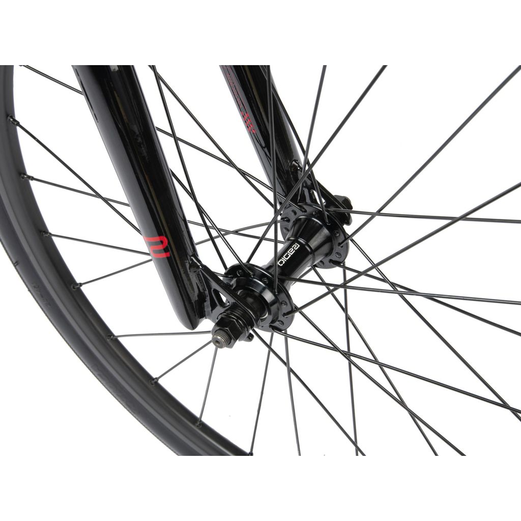 A close up of a Radio Xenon Mini Bike wheel with red spokes and a disc brake.