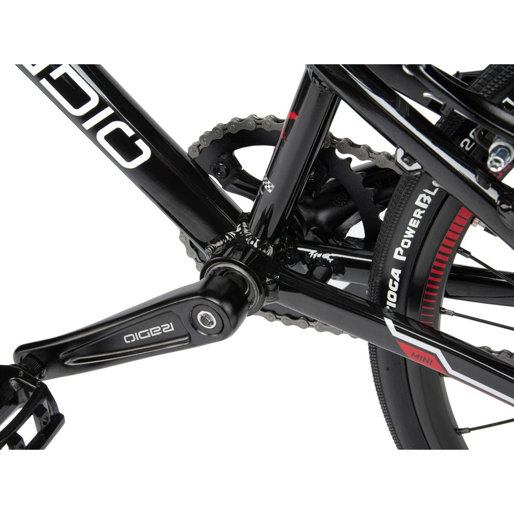 A close up of a Radio Xenon Mini Bike with a chain, pedals, and a disc brake.