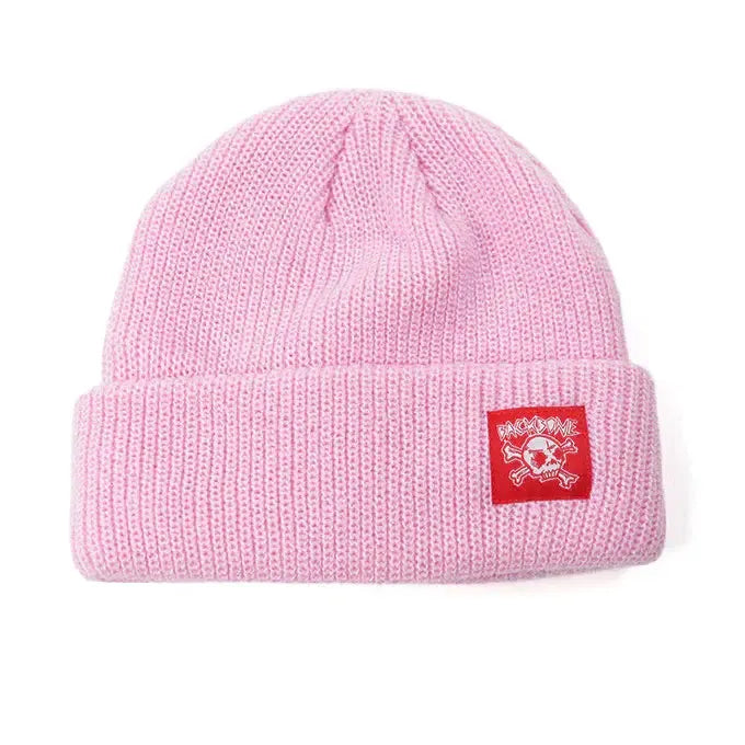 The Backbone Real Deal Beanie is a pink cuff beanie with a folded brim, featuring a red patch displaying the white Backbone Skull logo.