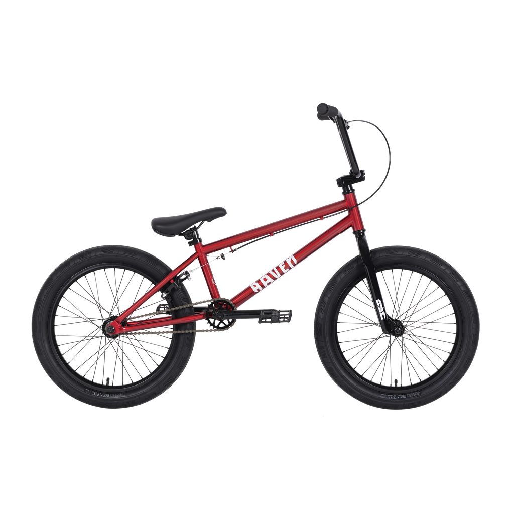 The Raven Trickster 20 Inch Bike boasts a striking red frame, black handlebars, saddle, and large tires. Built with hi-tensile steel for durability, this affordable BMX bike features black pedals and a reliable chain drive.