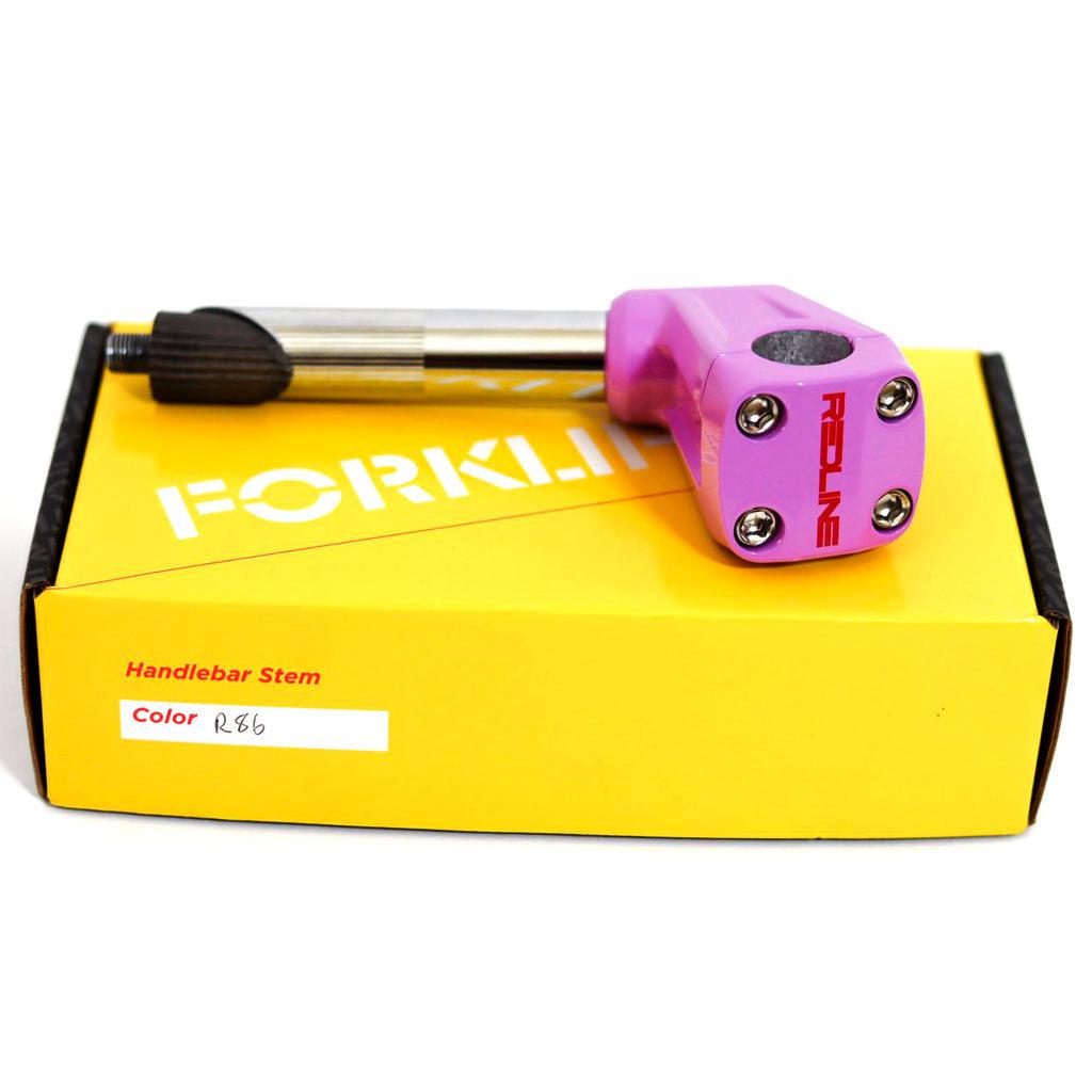 A pink REDLINE BY KASTAN Forklifter Front Load Stem rests on a yellow box marked "FORKLIF" and "Handlebar Stem." A sticker reads "Color: R.B6," highlighting its vibrant identity and hinting at BMX Freestyle prowess.