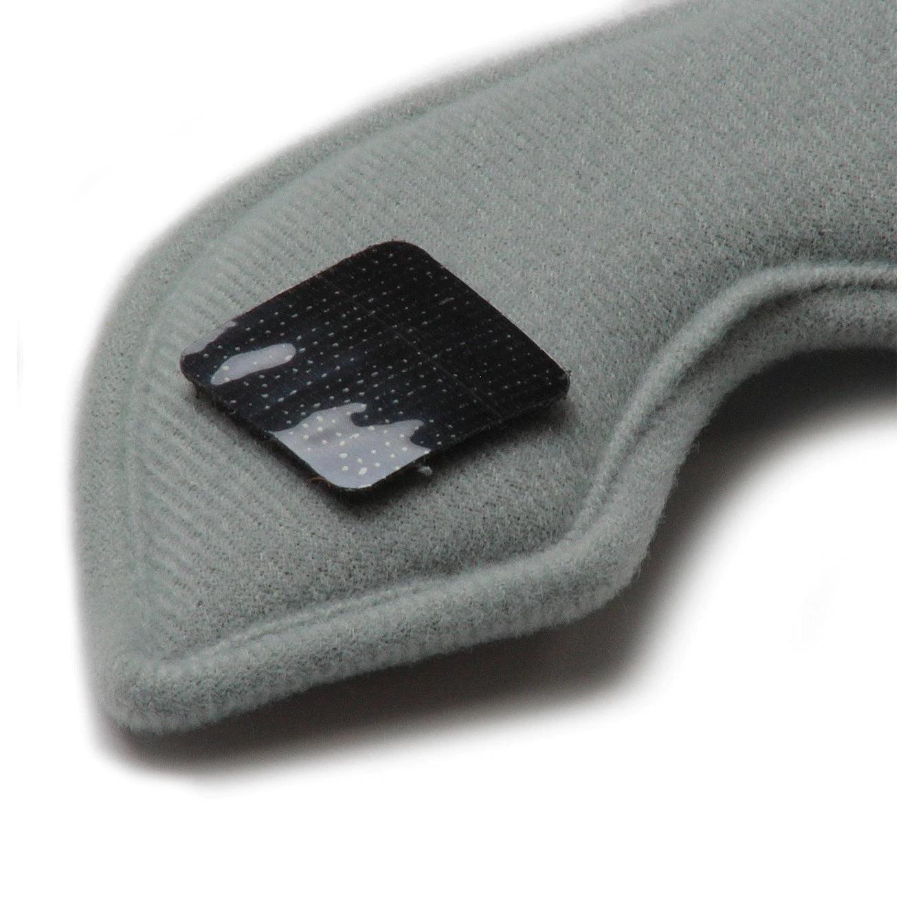 Close-up image of a grey fabric armrest or cushion with a black rectangular patch attached to it, featuring the washable sweat absorbing S-One Helmet Wide Terry Cloth Liner for added comfort.