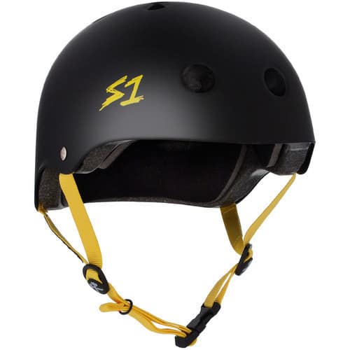 The S-One Helmet Lifer Black Matte/Yellow Straps features a yellow "S1" logo, yellow adjustable chin strap, ventilation holes, and multi-impact protection for reliable skate safety.