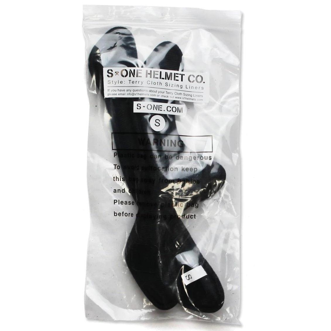 The S-One Lifer Terry Helmet Liner is a black, washable terry cloth liner for helmets, packed in a clear plastic bag with instructions and warnings on the packaging.