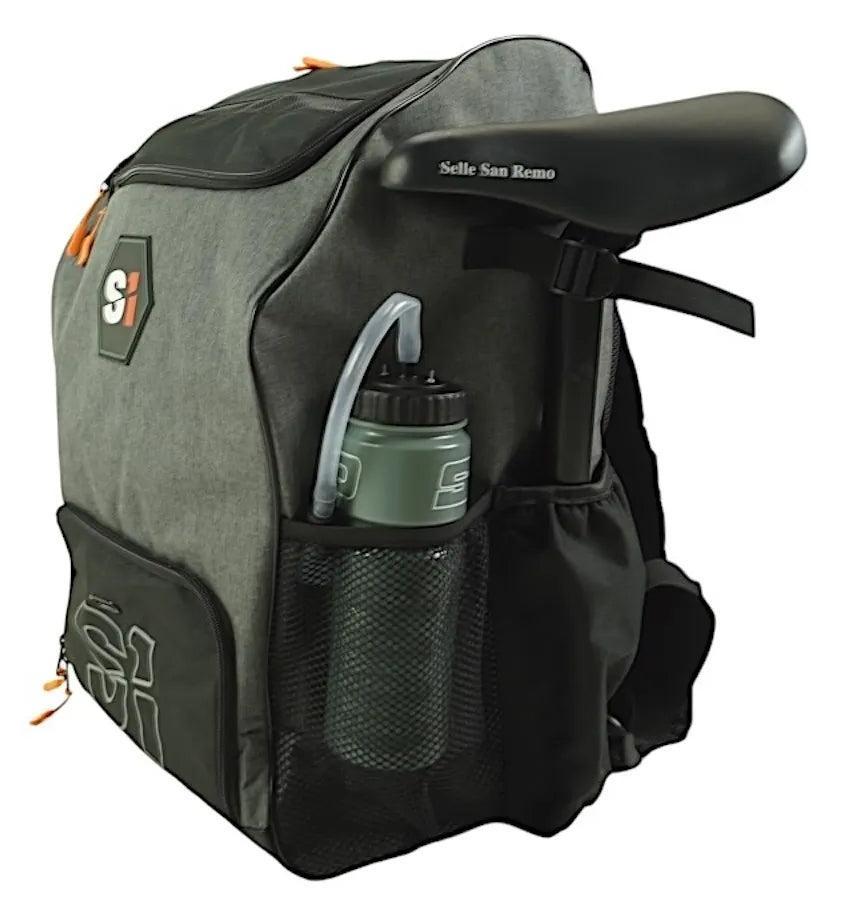 The gray S1 Helmet / Gear Backpack features a black mesh side pocket holding a water bottle, with a bicycle seat attached to the top.