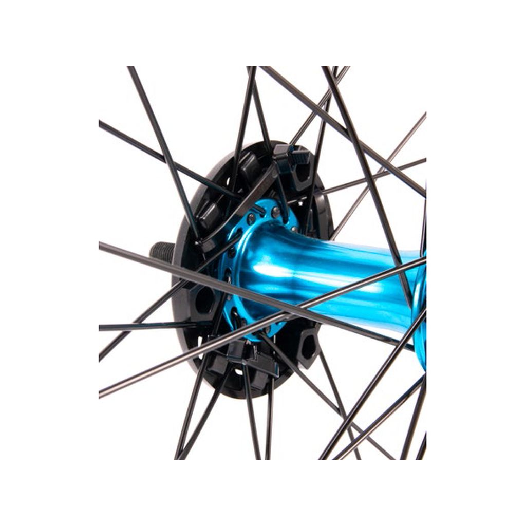 Close-up of a bicycle wheel hub showcasing the Salt Multi Universal Front Hub Guard with a blue center part and black spokes radiating outward, featuring an injected nylon fiberglass composite for enhanced durability.