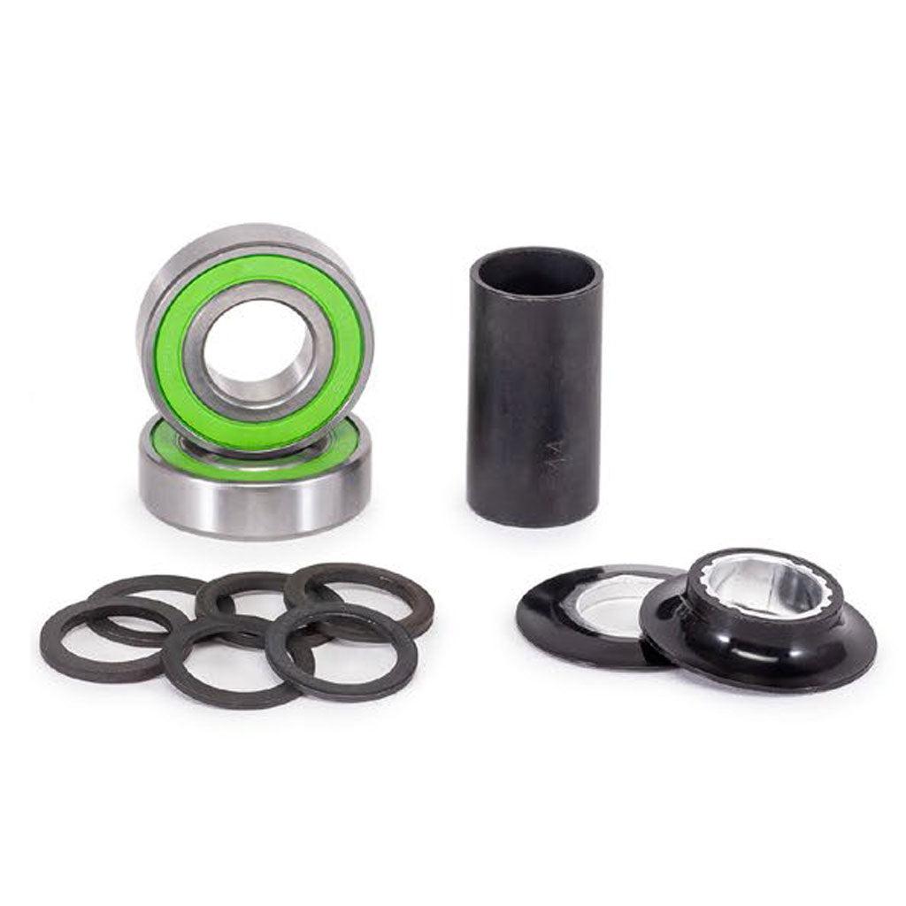 A Salt Plus Echo Mid Bottom Bracket, including sealed bearings, cylindrical spacers, and washers, alongside alloy CNC cones, all meticulously arranged on a white surface.