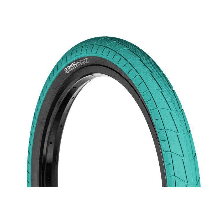 A Salt Tracer 16 Inch Tyre, teal with directional tread, is mounted on a black rim and displayed against a white background for improved traction.