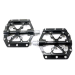 The SD CNC V3 Pro Pedal is a pair of black, flat BMX pedals with metal pins, silver axles, CNC machined bodies, and sealed bearings, shown side by side on a white background.