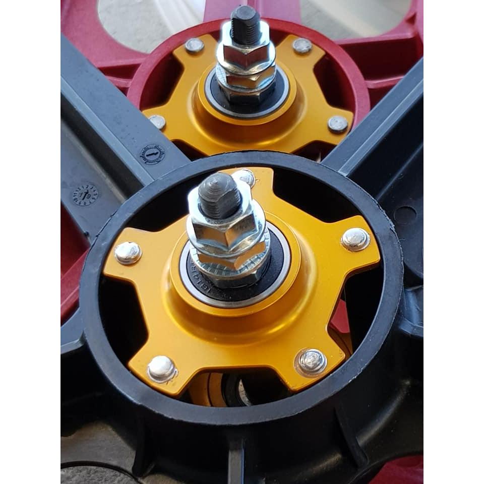 A close-up of two metallic mechanical components features yellow and red accents, ideal for retro rebuilds. Bolts and washers are visible on each piece, echoing the look of Skyway Tuff II Rivet 20 Collectors Edition Wheelset for a classic BMX bike appearance.