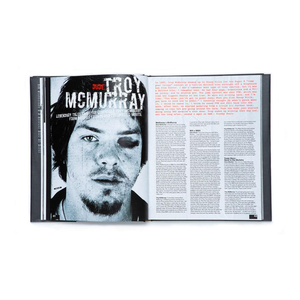 An open S&M Behind The Shield book with an image of a man with a beard holding a BMX bike.