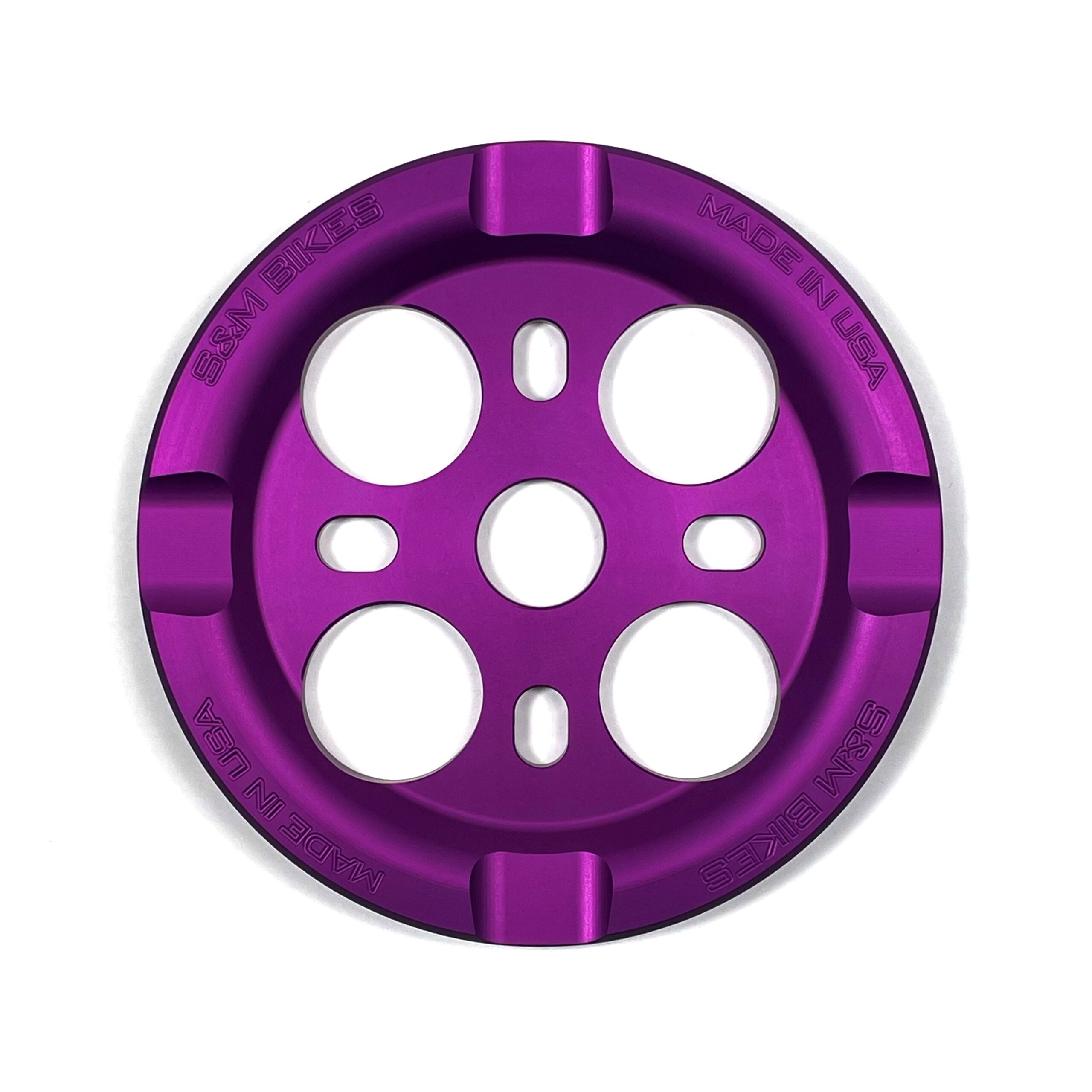 The S&M Mid School Guard Sprocket features a purple anodized circular design with four large holes and engraved "SSM BIKES" and "MADE IN USA" text.