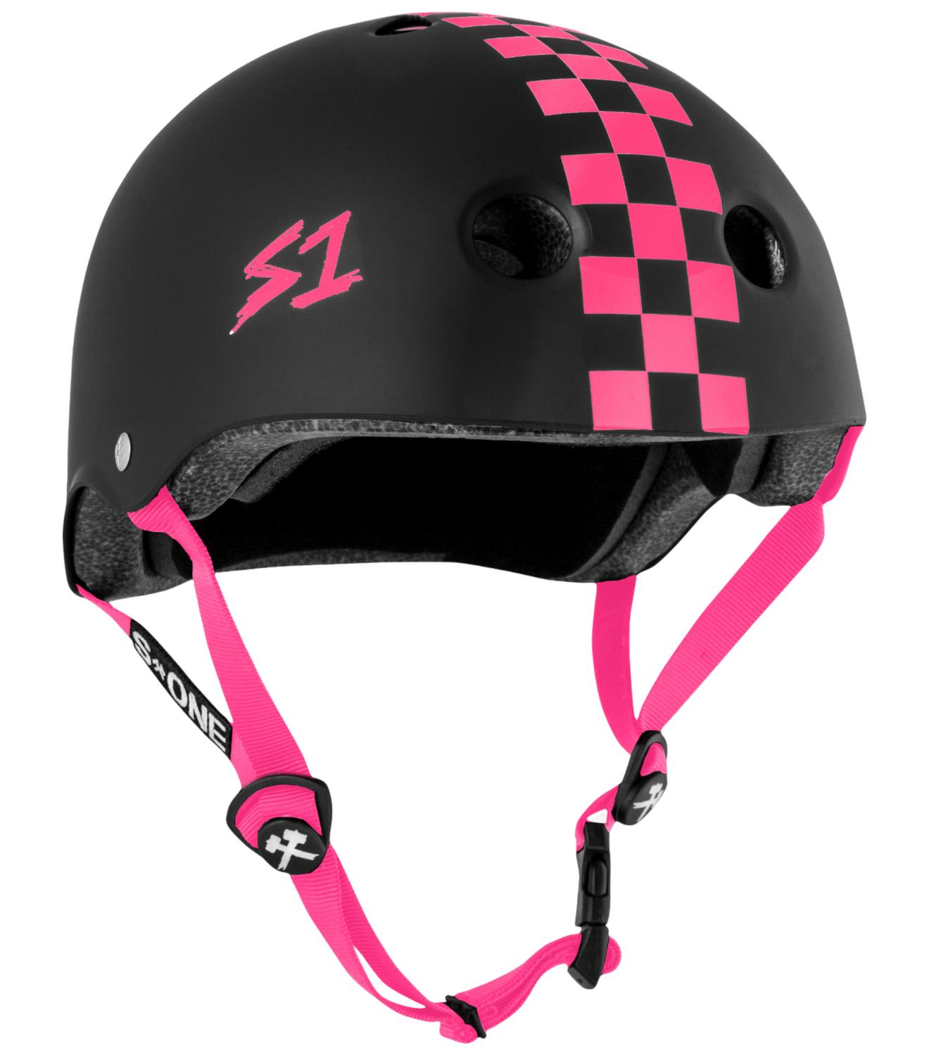 The S-One Lifer Helmet in Matte/Pink Checkers features a pink checkered stripe, pink "S1" logo, pink straps, vents, adjustable buckle, and certified multi-impact protection for safety and style.