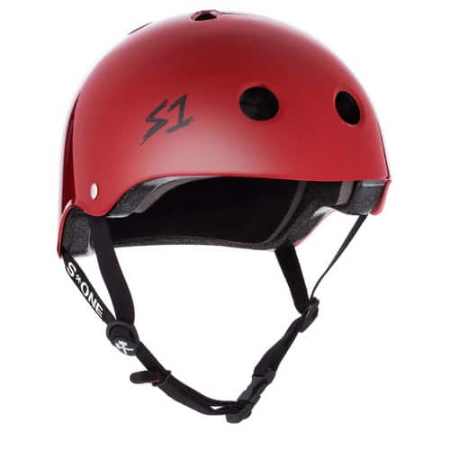 The S-One Helmet Lifer Blood Red Matte features ventilation holes, an adjustable black chin strap, and the "S1" logo. This Australian-certified helmet provides reliable high-impact protection for skateboarders.