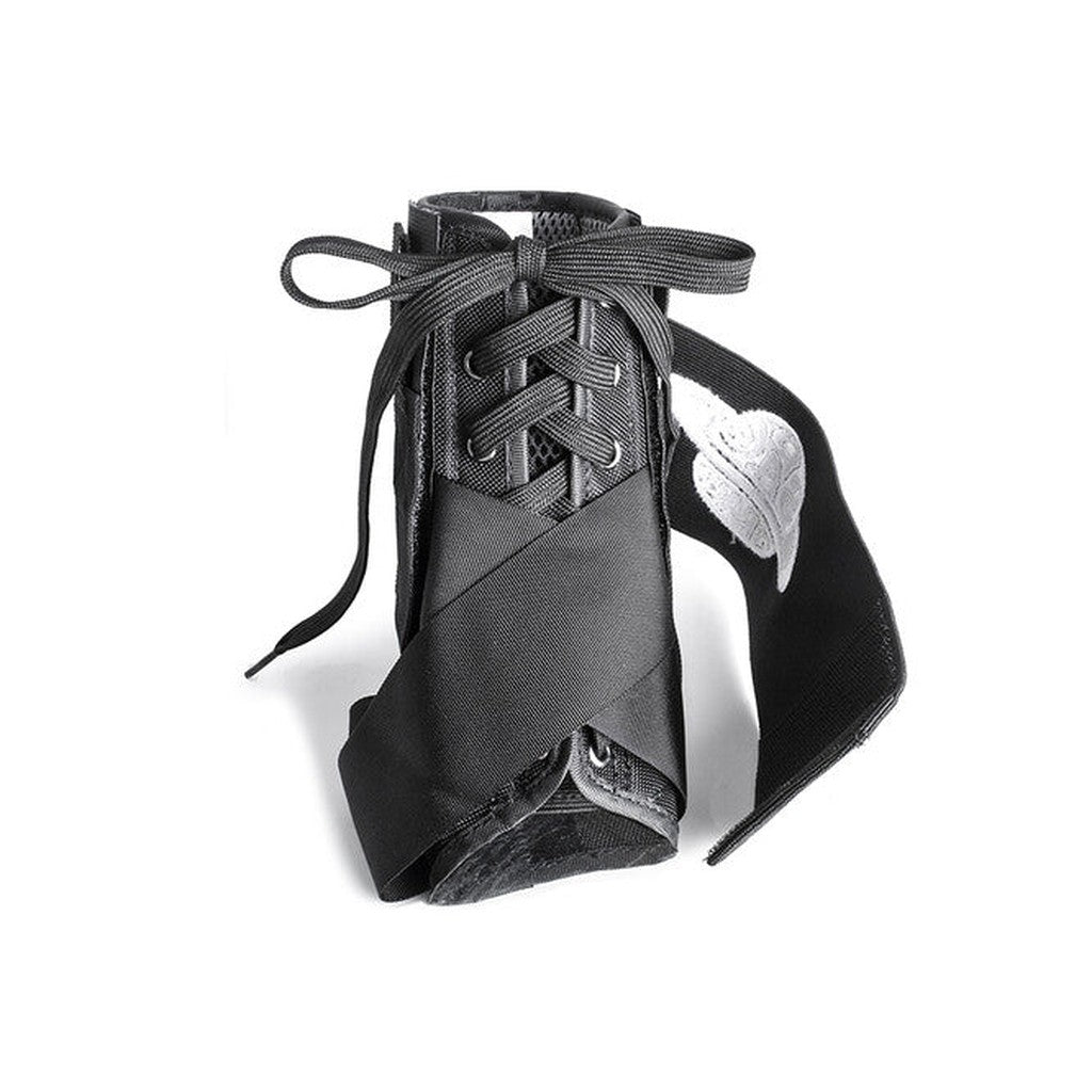 The Space Brace Ankle Brace V1 is a black shoe inspired by pointe ballet shoes and sneakers, featuring ribbon laces, a white embroidered leaf on one side, and discreet ankle support for enhanced comfort.