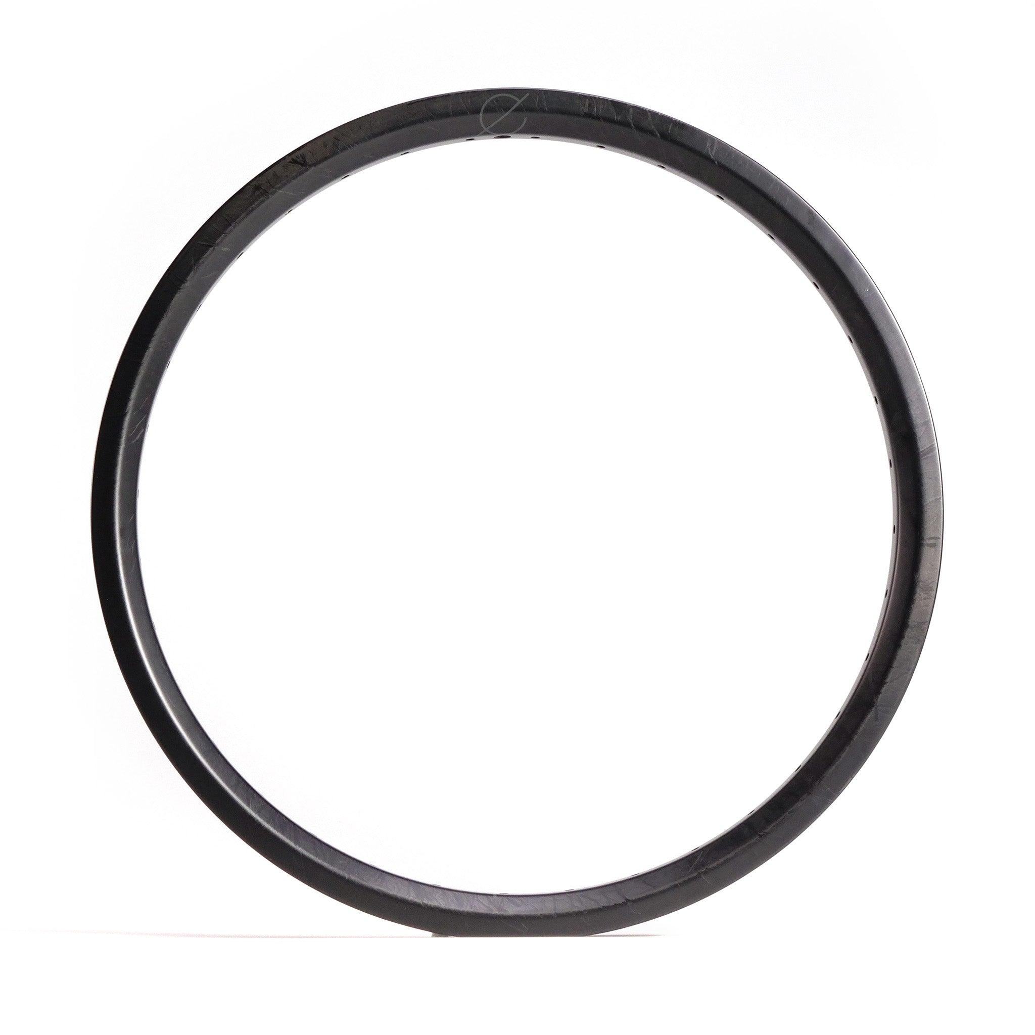 A Spectre NME Carbon Fiber 20 Inch Brakeless Rim with a smooth, black surface stands upright against a plain white background.