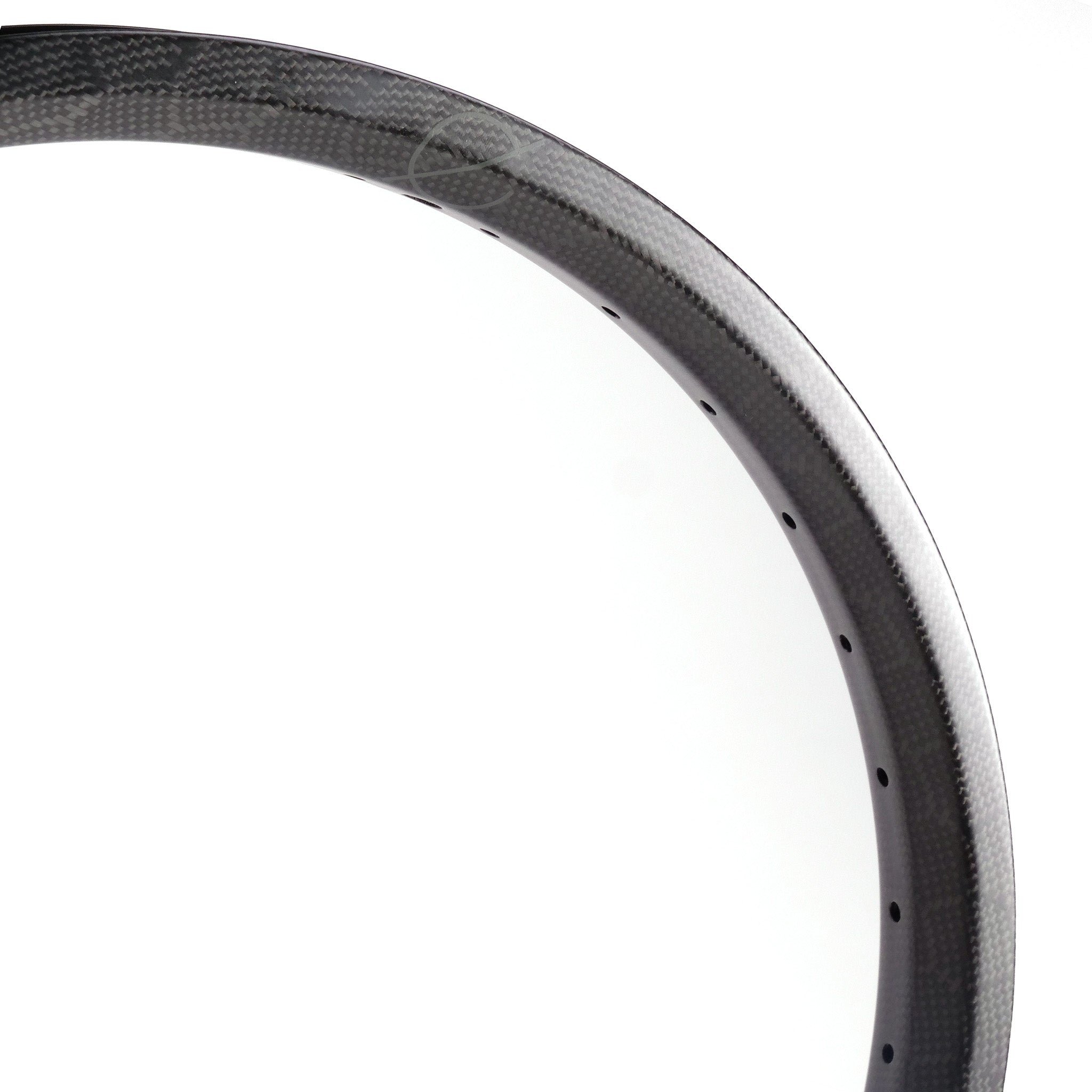 Close-up view of the Spectre NME Carbon Fiber 20 Inch Brakeless Rim in black, featuring visible spoke holes, set against a plain white background.