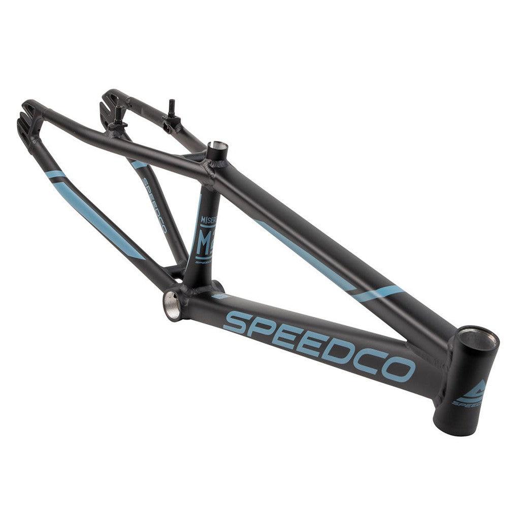 A matte black Speedco M2 Expert Cruiser Frame with light blue accents and branding is shown from the side on a white background, highlighting the lightweight performance of its aluminium construction.