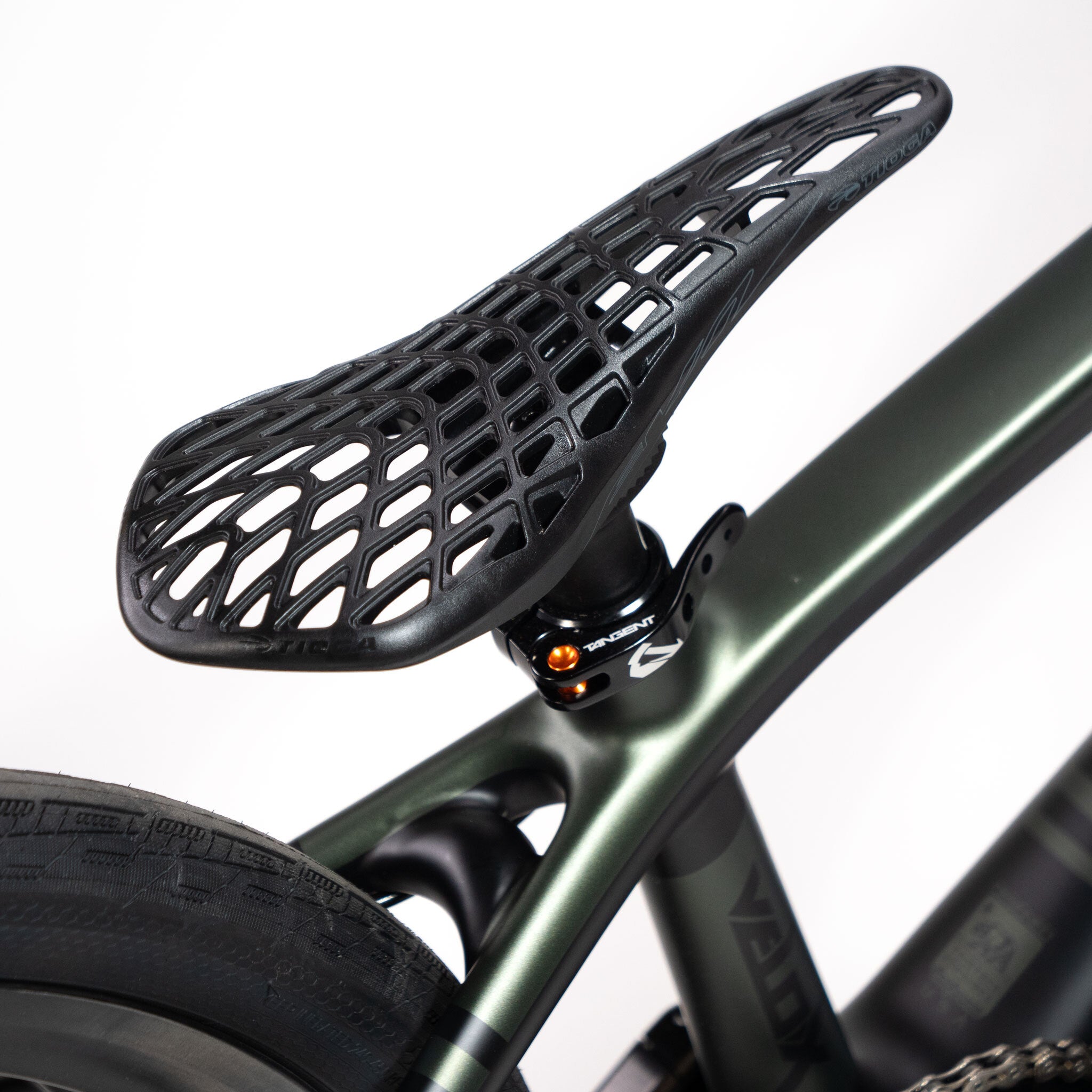 Close-up of a modern bicycle seat featuring a black, lattice-patterned design on a dark green Speedco Velox Pro XL Cruiser Custom Bike frame, ideal for any carbon race rig or cruiser enthusiast.