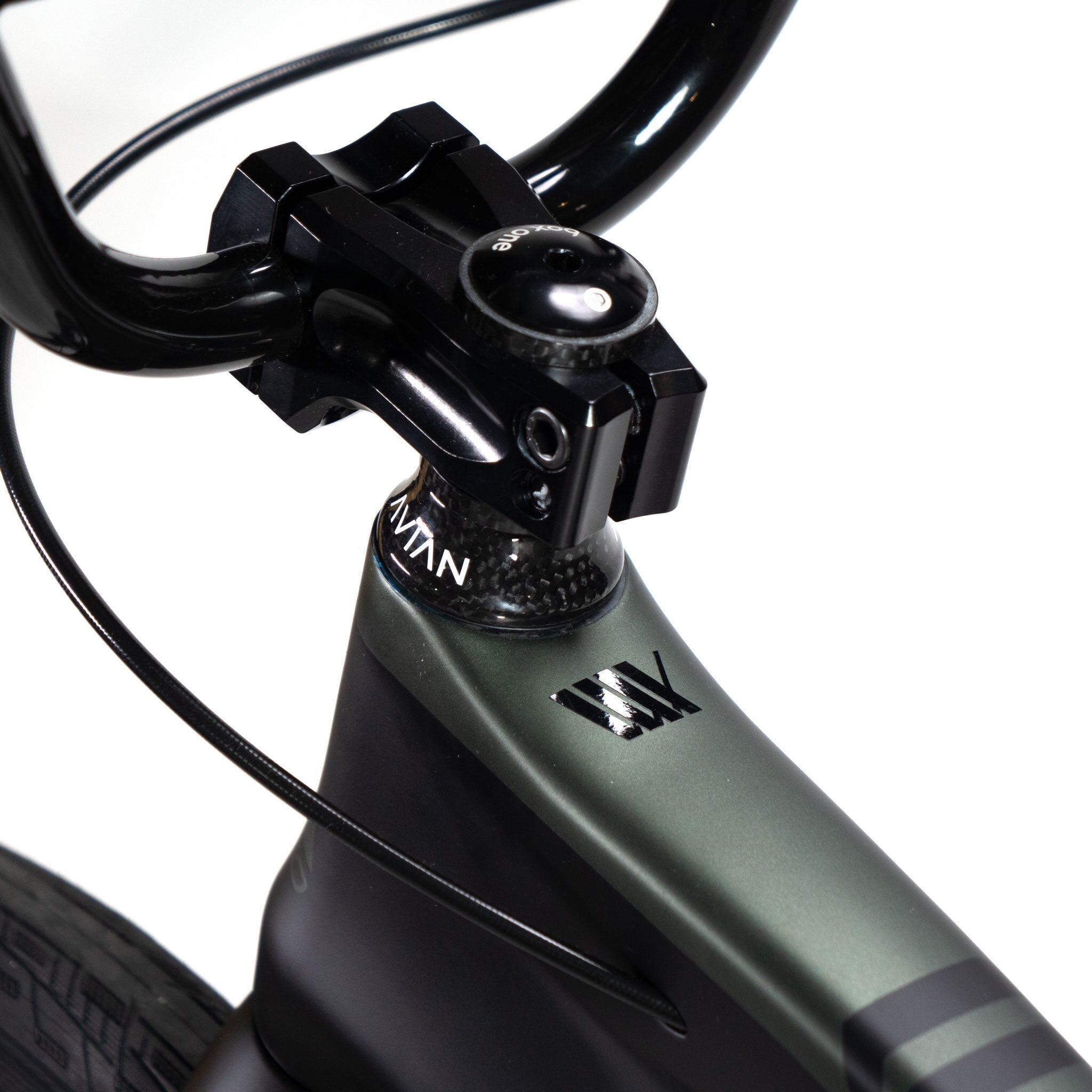 Close-up of the Speedco Velox Pro XL Cruiser Custom Bike's black handlebars and stem, showcasing a vibrant green frame with visible cables.