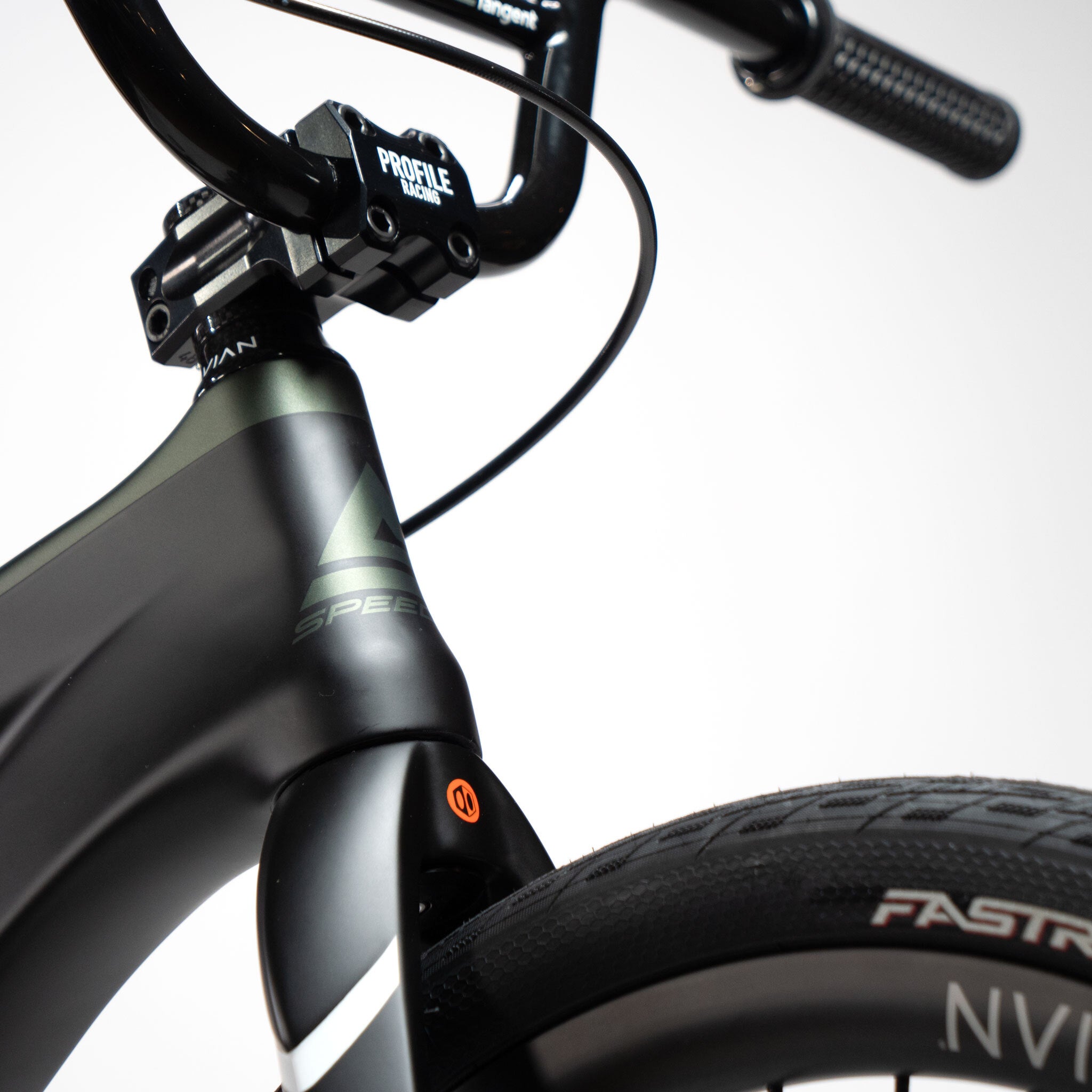 Close-up of the front end of a black carbon race rig, highlighting the handlebars, stem, and front tire with visible branding and logos of the Speedco Velox Pro XL Cruiser Custom Bike.