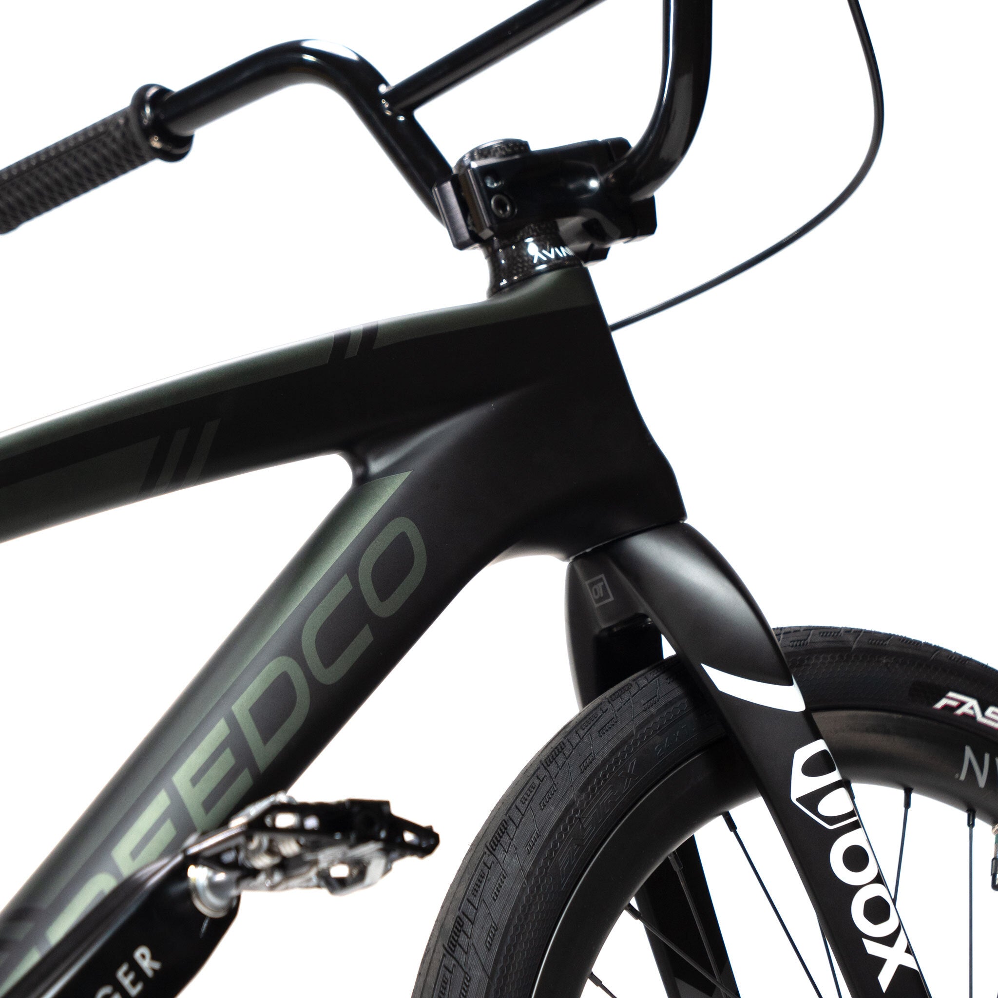 Close-up of the front section of a black Speedco Velox Pro XL Cruiser Custom Bike, highlighting the handlebars, frame with "SPEEDCO" branding, and a thick tire. This carbon race rig exudes power and precision for enthusiasts who crave speed and style.