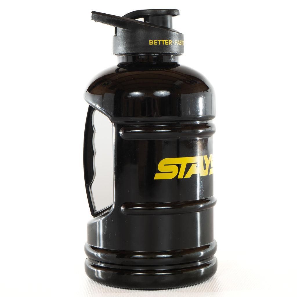 The Stay Strong Water Cannister 2.0 Litre is a black water bottle adorned with a yellow "STAY STRONG" logo and a cap that reads "BETTER, FASTER." It boasts an ergonomic handle on the side for easy carrying.