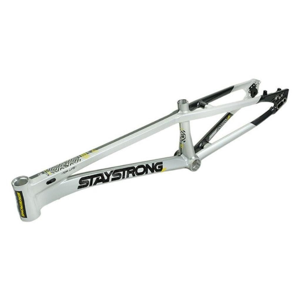 White Staystrong V5.1 Pro XXXXL Disc BMX race frame featuring black and yellow "STAY STRONG" branding, displayed without wheels or components and isolated on a white background. This model is engineered with race geometry to deliver optimum track performance.
