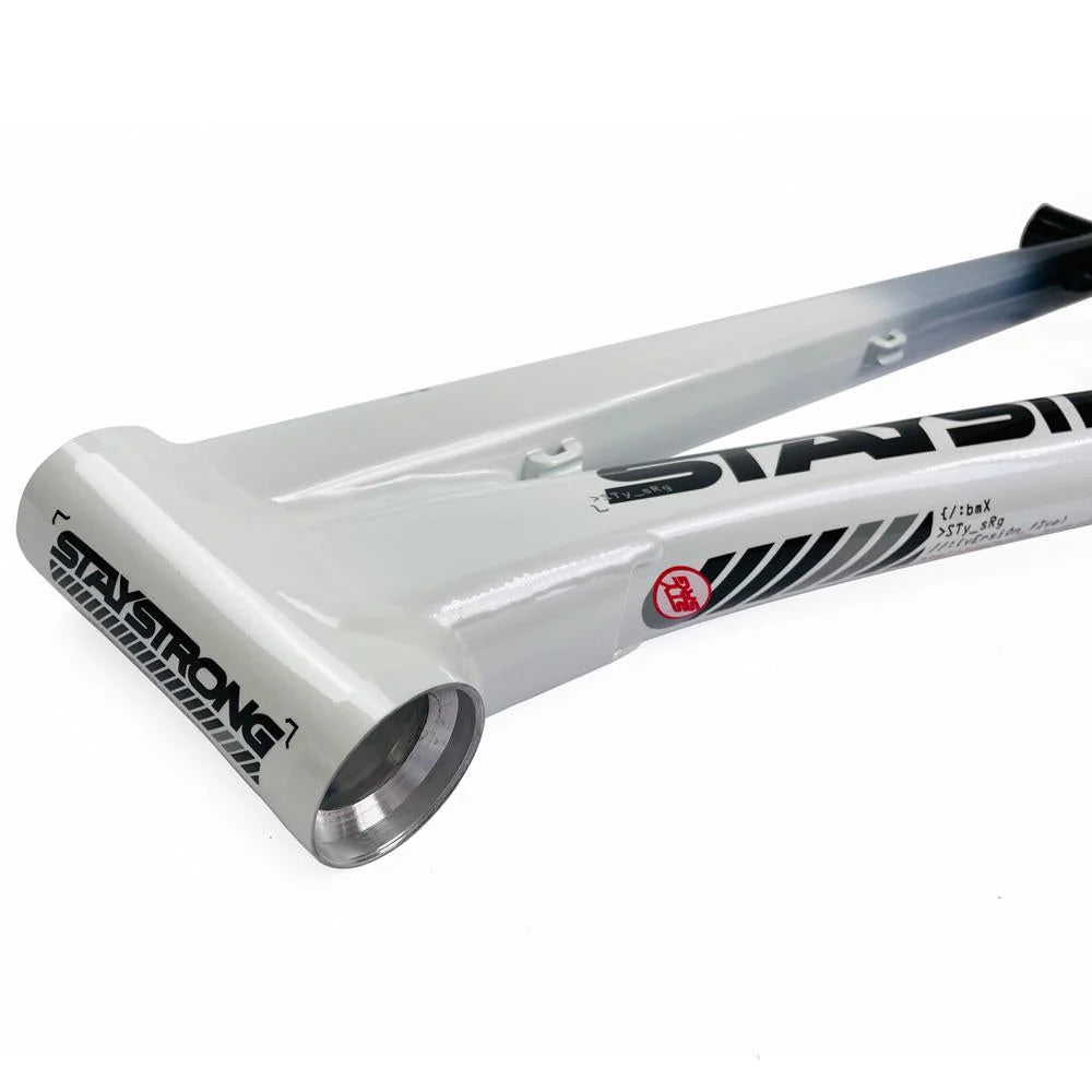 Image of a white BMX bike frame with a "Stay Strong" logo, visible bottom bracket shell, and black "STAYSTRONG" text along the top tube. Crafted from 6061 alloy tubing, this Staystrong V5 Disc Expert XL Frame is built for durability and performance.