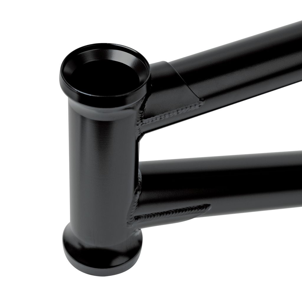 Close-up view of a black metallic structure, featuring welded joints and cylindrical components crafted from durable Japanese Chromoly tubing.