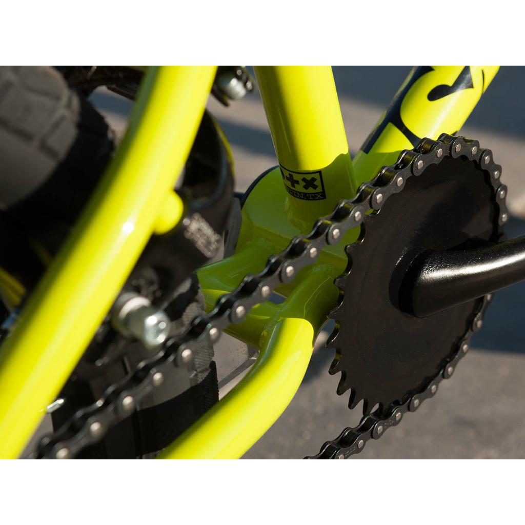 Close-up of the Sunday Blueprint 16 Inch Bike’s yellow frame, highlighting the chain, crankset, and rear tire with scaled-down geometry inspired by the original Sunday Blueprint.