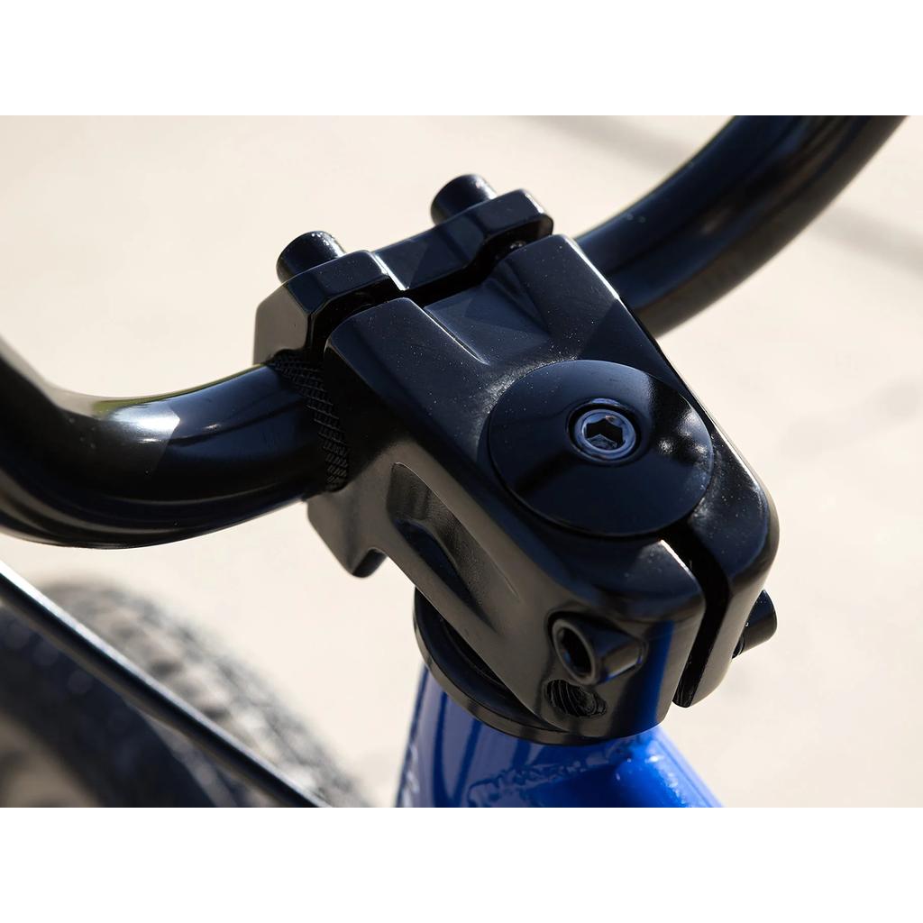 Close-up of a black bicycle stem securing handlebars to the blue frame of the Sunday Blueprint 16 Inch Bike, showcasing bolts, textured grips, and precise BMX geometry.