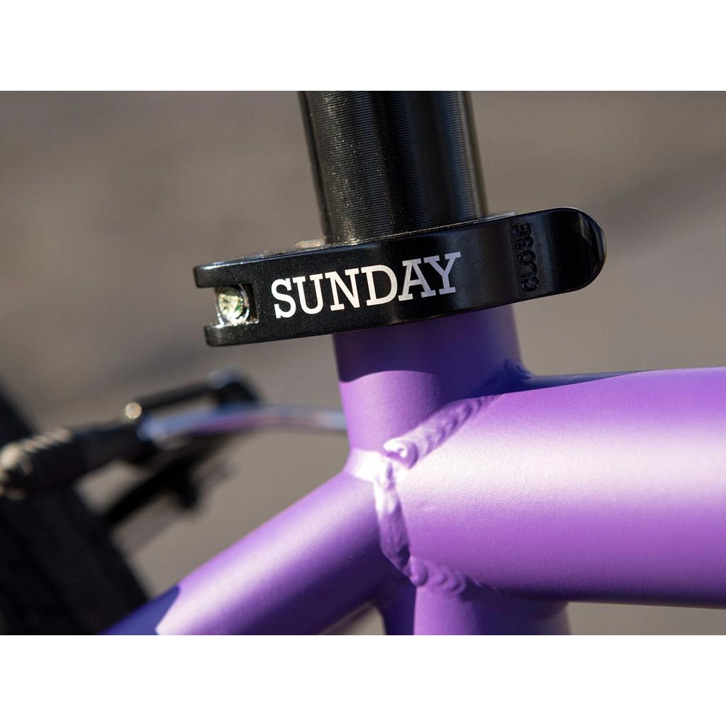 Close-up of the Sunday High C 29 Inch Bike (2025) shows its purple chromoly frame and black "SUNDAY" seat clamp, highlighting the quality geometry found in many 29" bikes.