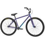 The Sunday High C 29 Inch Bike (2025) is a purple single-speed cruiser with a chromoly frame, black handlebars, seat, and tires featuring yellow Maxxis branding on both 29" wheels.