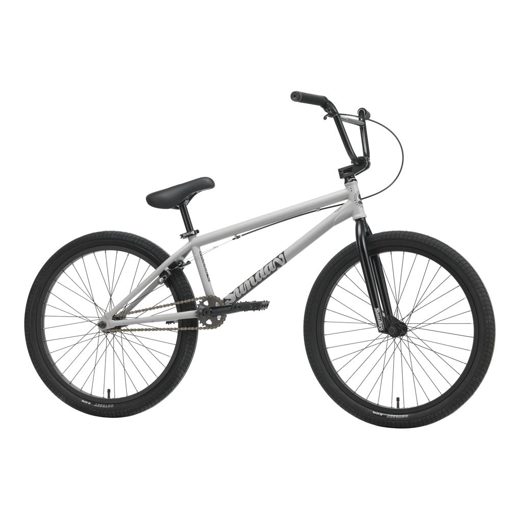 The Sunday Model C 24 Inch Bike is shown from the side against a white background. It features a gray chromoly frame, black handlebars, seat, tires, and fork.