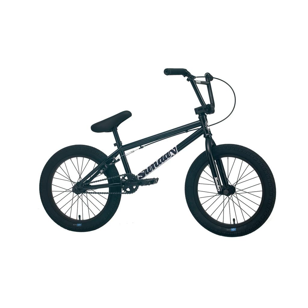 The Sunday Primer 18 Inch Bike (2025) is shown on a white background, featuring a black frame, thick tires, single gear, fully sealed cassette hub, compact build, and straight handlebars.