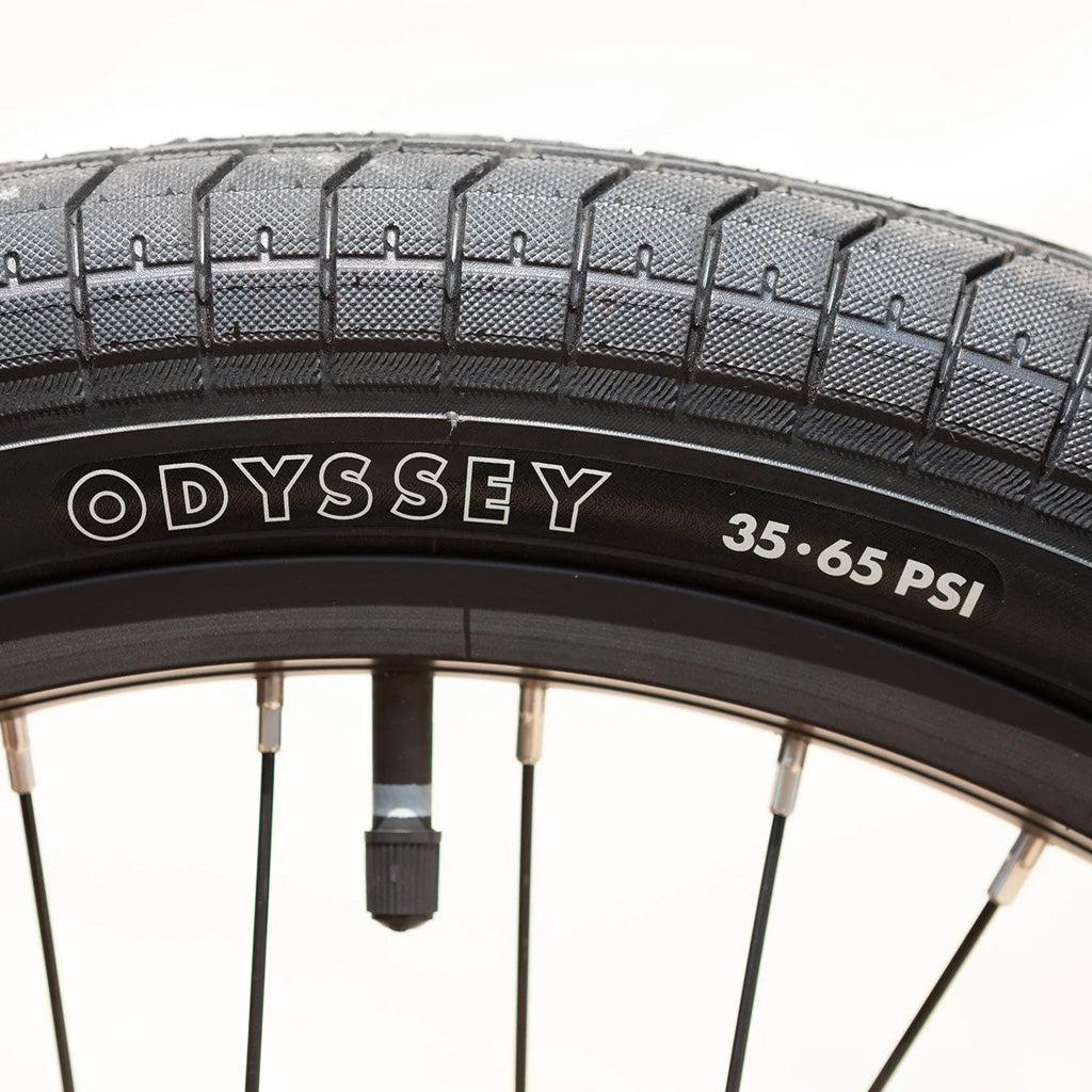 Close-up image of a bicycle tire with "Odyssey" branding and a recommended pressure range of 35-65 PSI, ideal for the Sunday Primer 20 Inch Bike.