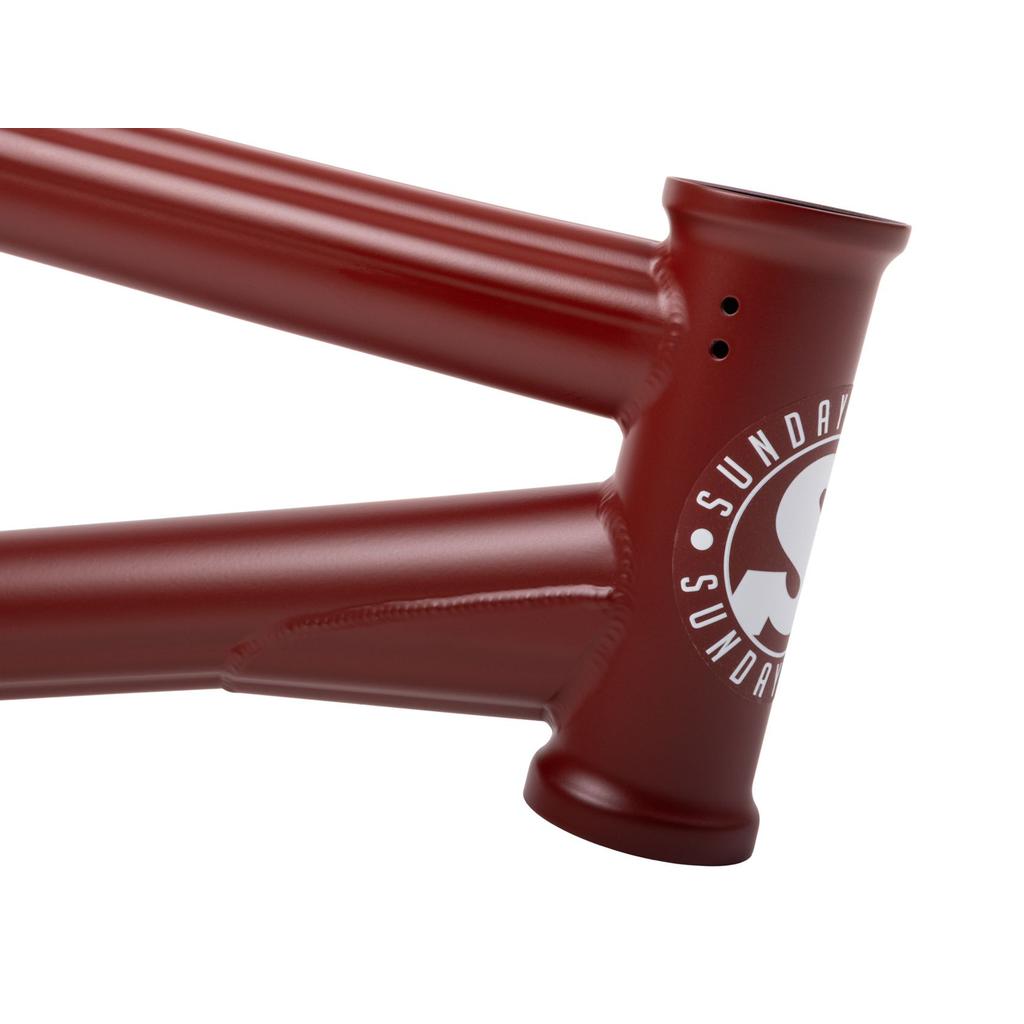 Close-up of the Sunday Soundwave V3 Frame in red, featuring a white "SUNDAY" logo on the head tube junction; built from strong 4130 Chromoly and backed by a 41-Thermal Lifetime Warranty.