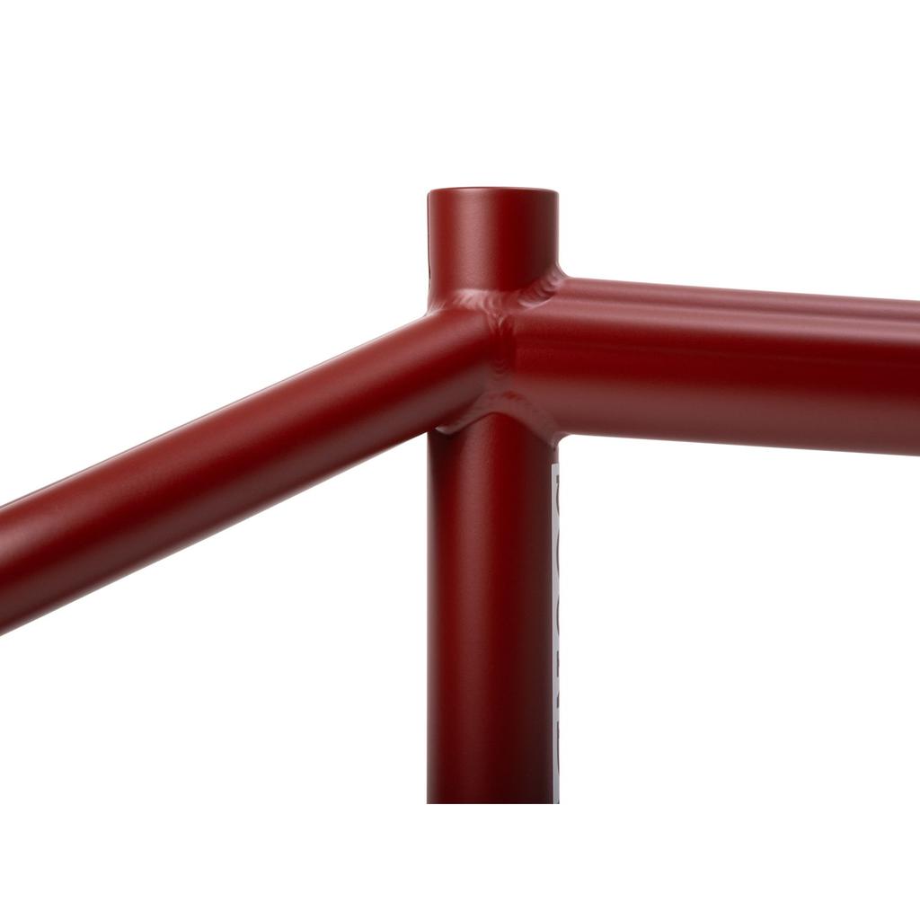 Close-up of the red Sunday Soundwave V3 Frame, showing the intersection of three tubes with visible welds on its robust 4130 Chromoly construction.
