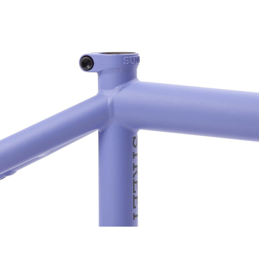 Close-up of the Sunday Street Sweeper Frame (Jake Seeley Signature) in lavender, showcasing the junction between the top tube and seat tube with visible welding lines. Crafted from 4130 Chromoly for durability and performance.