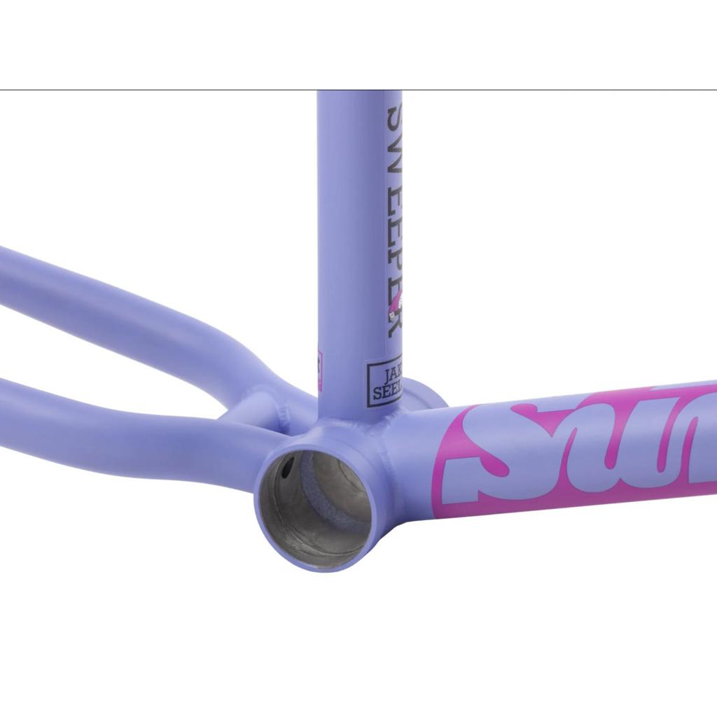 A close-up of the Sunday Street Sweeper Frame (Jake Seeley Signature) in lavender, highlighting pink and white lettering on the bottom bracket area and rear stays.